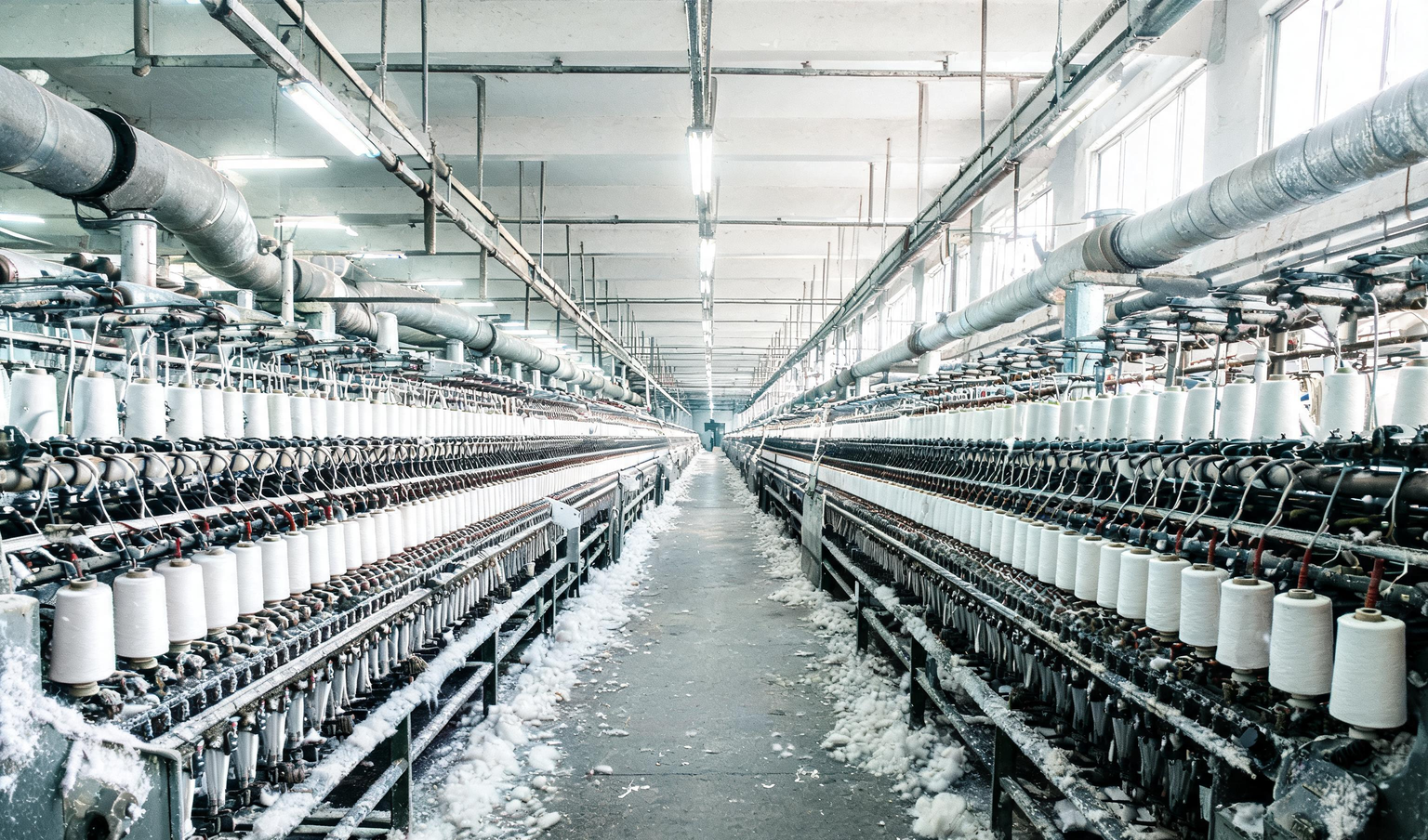 Idle ring spinning frames with yarn bobbins in a spinning mill near Coimbatore, the kind of production line a process audit covers