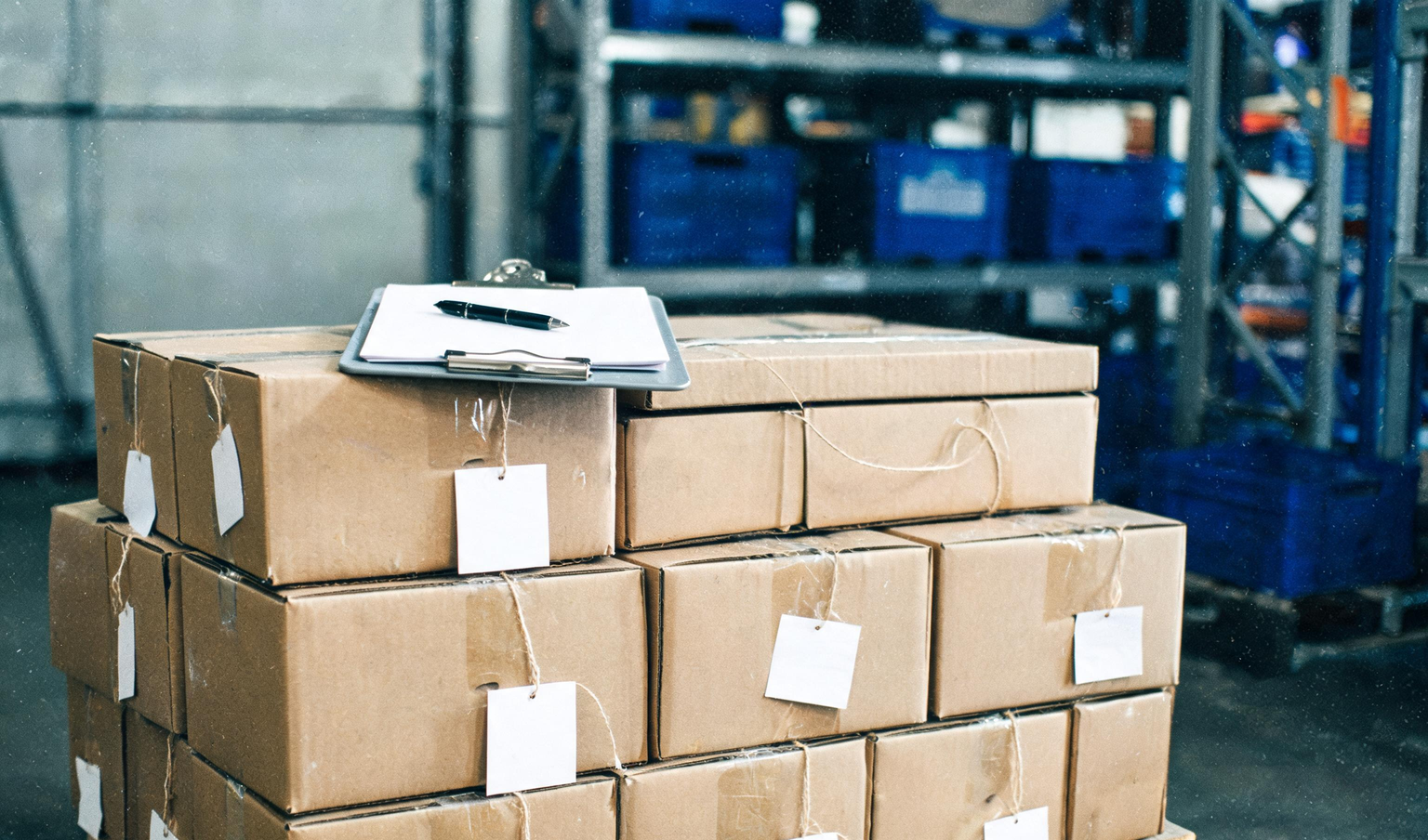 Pallet of cartons with count tags and a clipboard, the kind of stock checked in a physical stock verification