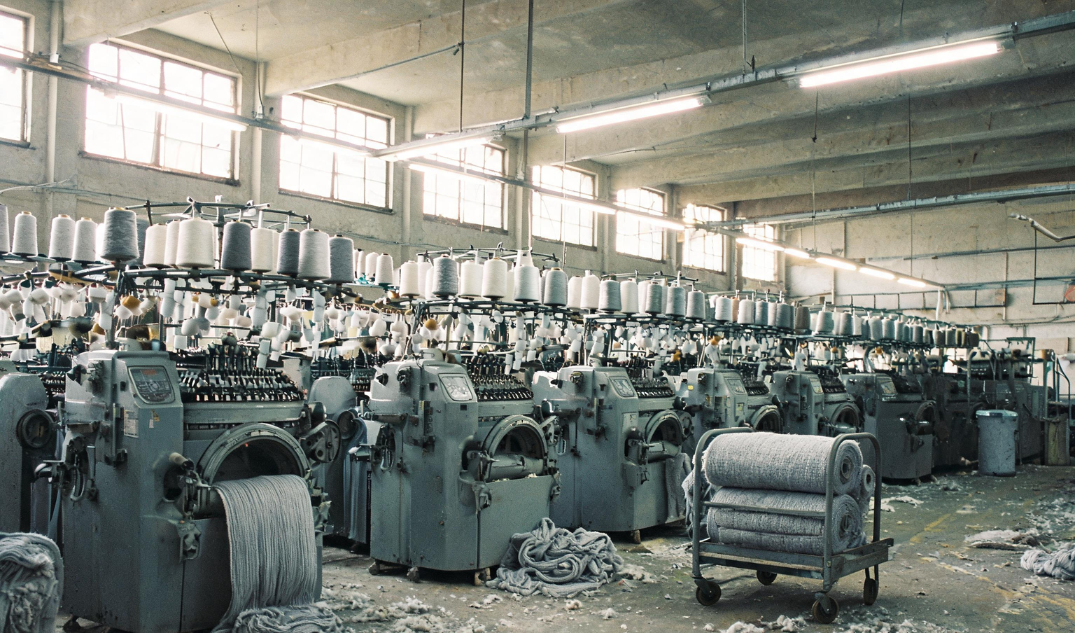 Knitting machines with cotton yarn cones at a textile unit in Tirupur, the kind of mill an internal audit covers